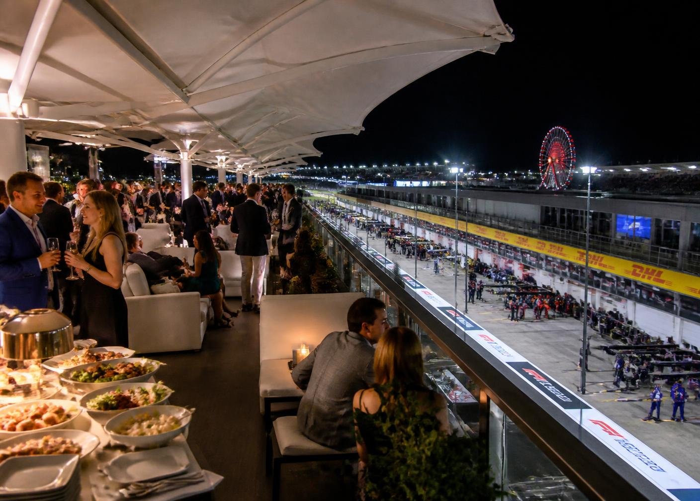 Paddock Club rooftop terrace above the floodlit pit lane at night